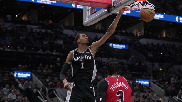 Spurs center Victor Wembanyama dunks in front of Chicago Bulls center Andre Drummond (3) in the second half at the Frost Bank Center.
